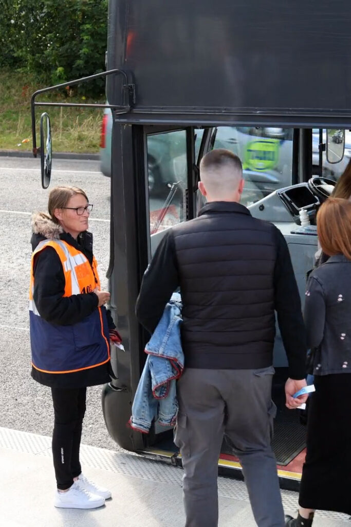 Marathon Contract Transport Services​ female employee managing and guiding students on to a bus